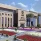 واجهة جامعة أهلية حديثة التصميم بحديقة أمامية مزينة بالزهور
